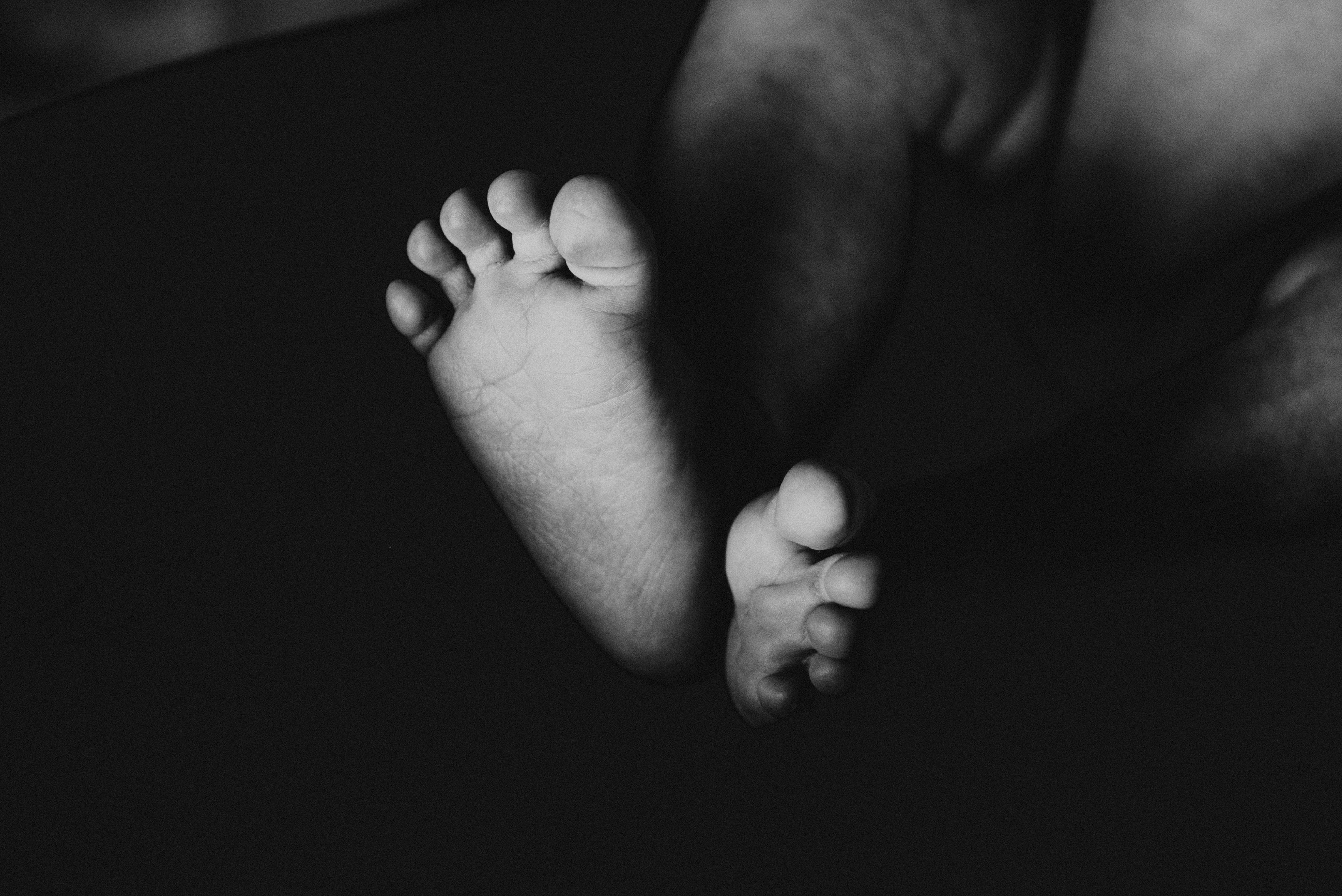 grayscale photography of baby s feet