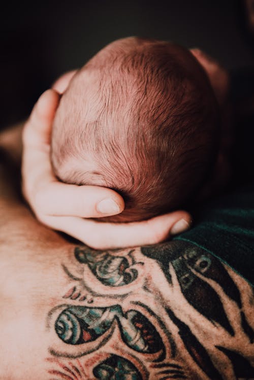 Free Person Holding Head of Baby Stock Photo