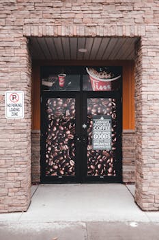 Entrance of Tim Hortons with a coffee-themed door and brick facade.