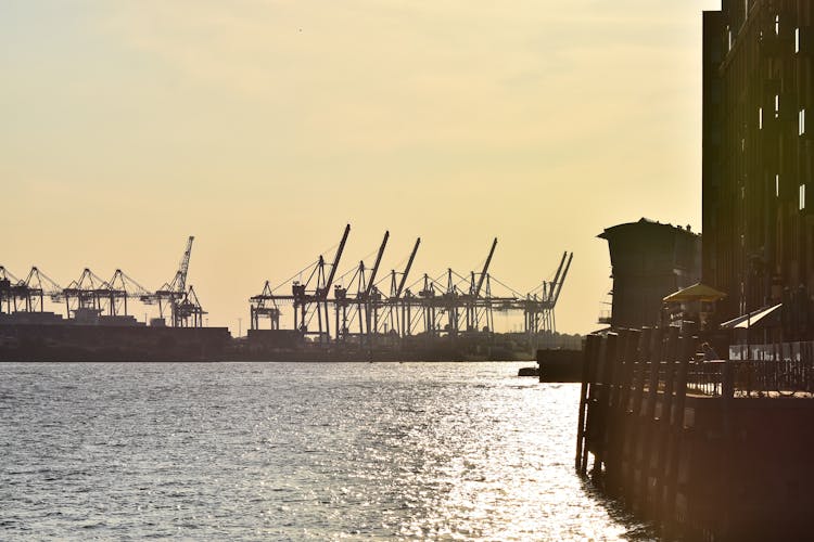 Cranes In A Commercial Dock At Dusk