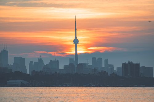 Free Dramatic view of Toronto skyline during sunset, highlighting the silhouette of the iconic CN Tower. Stock Photo