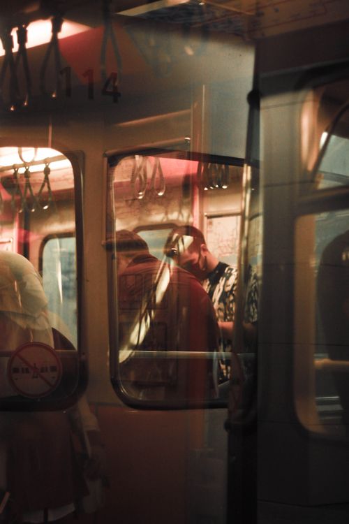 Free Shadowy figure reflections in a dimly lit subway car during a nighttime commute. Stock Photo
