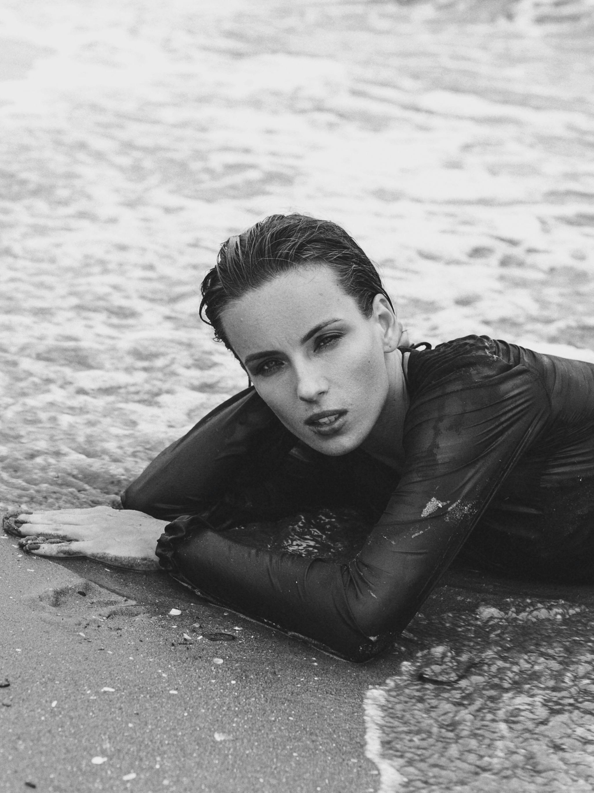 woman laying on coast and posing