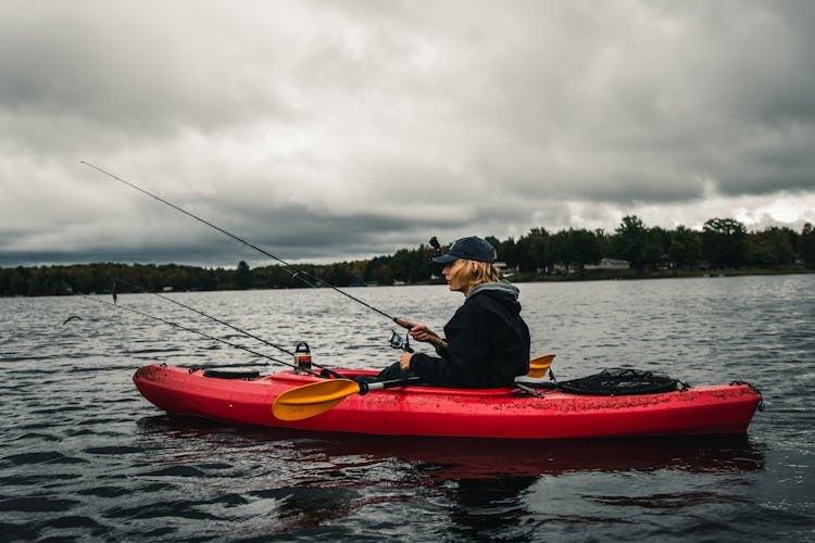 Man Sitting In A Kayak Fishing