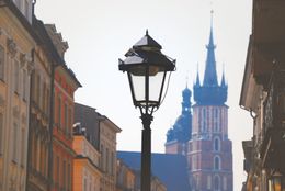 A lamp post and church spires in Kraków — photo by Jade on Pexels