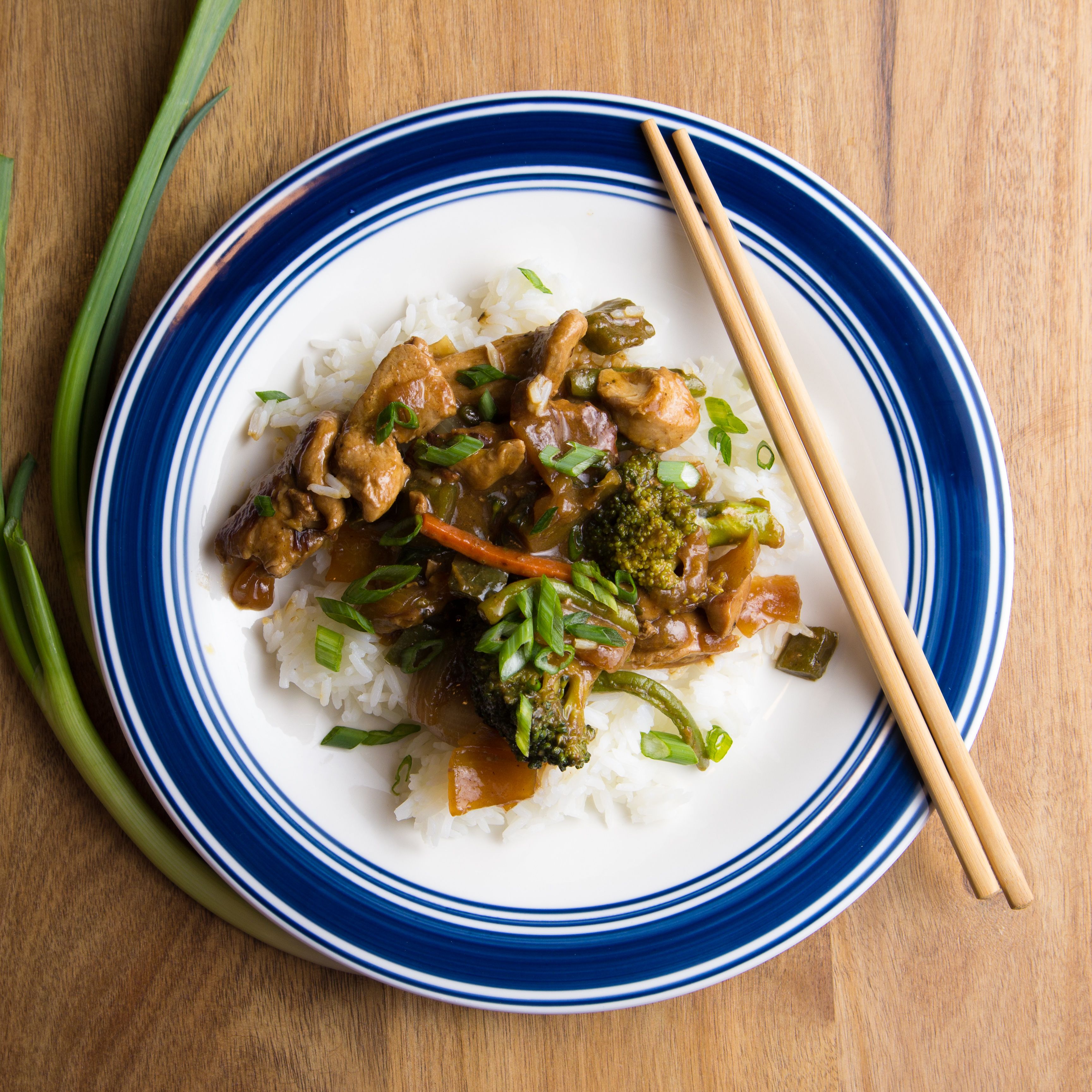 Stir-fried chicken and vegetables over steamed rice — photo by Brandon Benedict on Pexels
