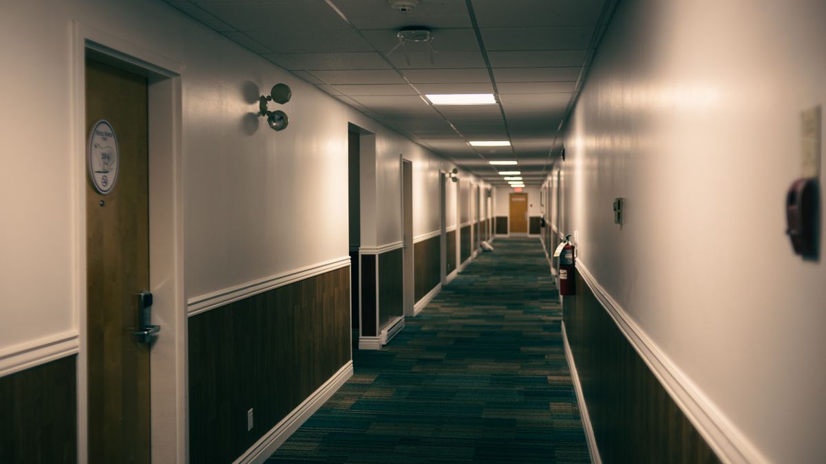 A quiet carpeted hotel hallway away from the elevator bank in 2026
