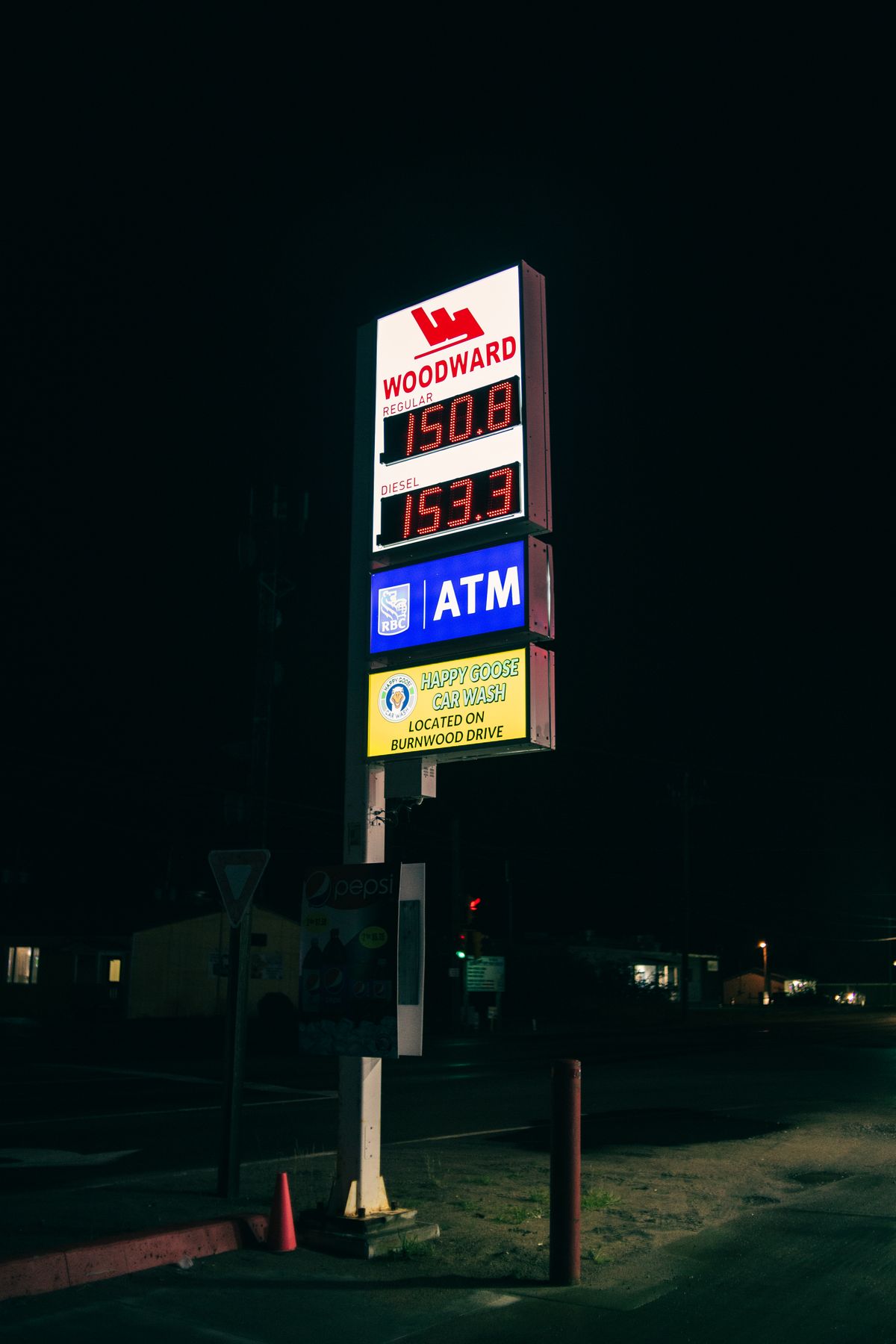 Illuminated fuel price sign at night