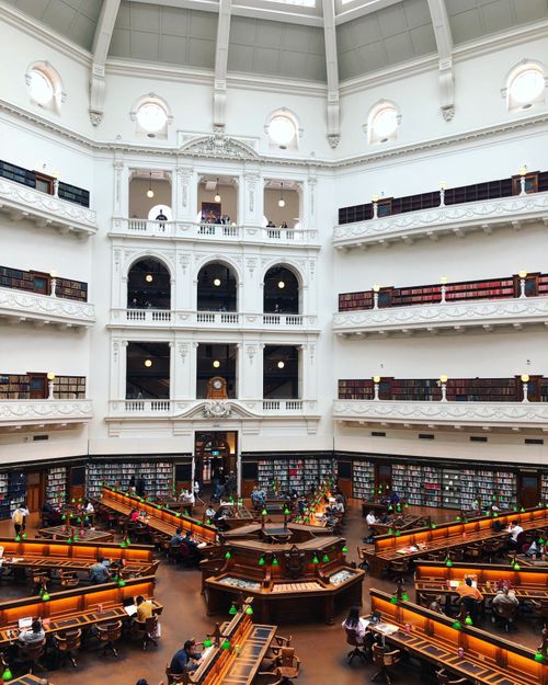 Free A grand view of the State Library of Victoria's reading room in Melbourne, Australia, bustling with activity. Stock Photo