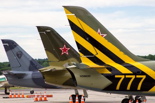 Free Vibrant fighter jet tails with unique designs parked at Rome, NY airport. Stock Photo