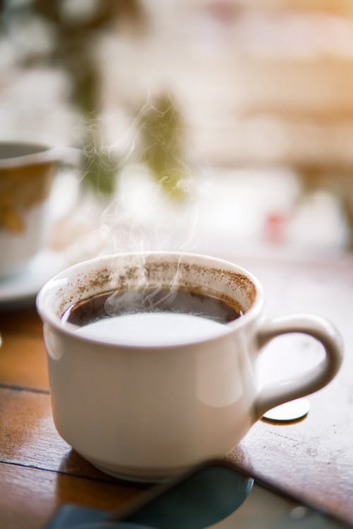 A White Ceramic Mug With Coffee