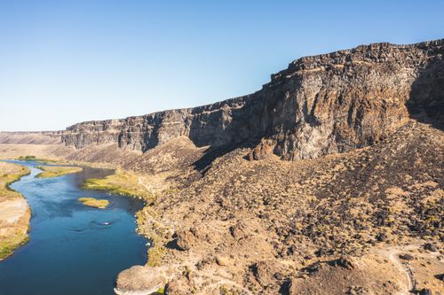 Free A breathtaking view of rocky cliffs and a winding river under a clear blue sky in Boise, Idaho. Stock Photo