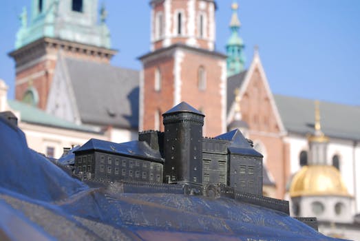 Detailed miniature of Wawel Cathedral set against the backdrop of the actual structure in Kraków, Poland.