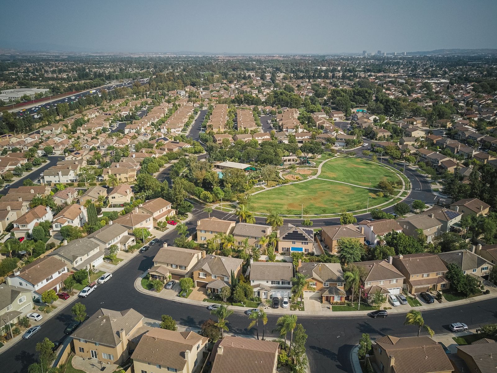 Aerial drone view of a suburban residential neighborhood — real estate services