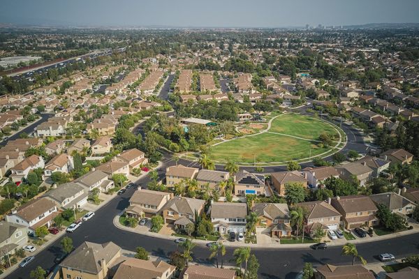 Drone shot of a spacious suburban neighborhood with central park