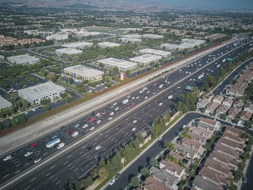 Fotos de stock gratuitas de carretera, casas, coches en movimiento