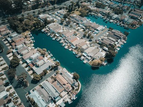A beautiful aerial view of waterfront houses in a suburban neighborhood, highlighting residential architecture.