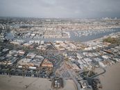 Aerial View of City Buildings and Boats Near Body of Water