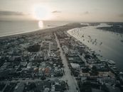Aerial View of City Near Sea at Sunset