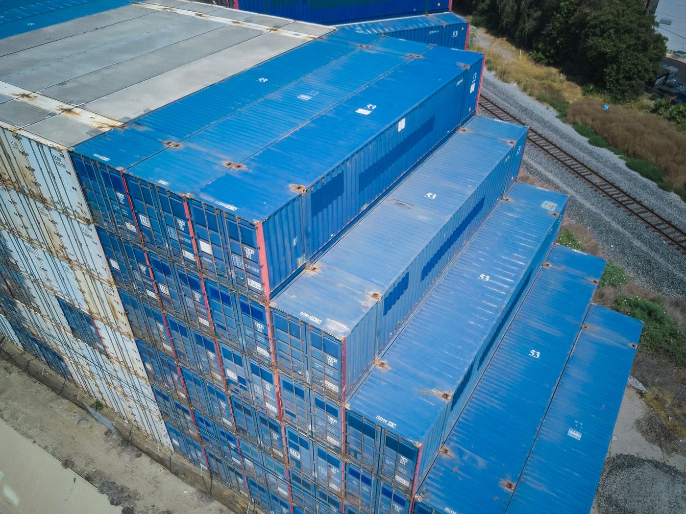 Blue cargo containers stacked in a logistics yard