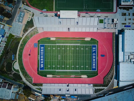 Drone shot capturing El Camino sports complex with football field and track.