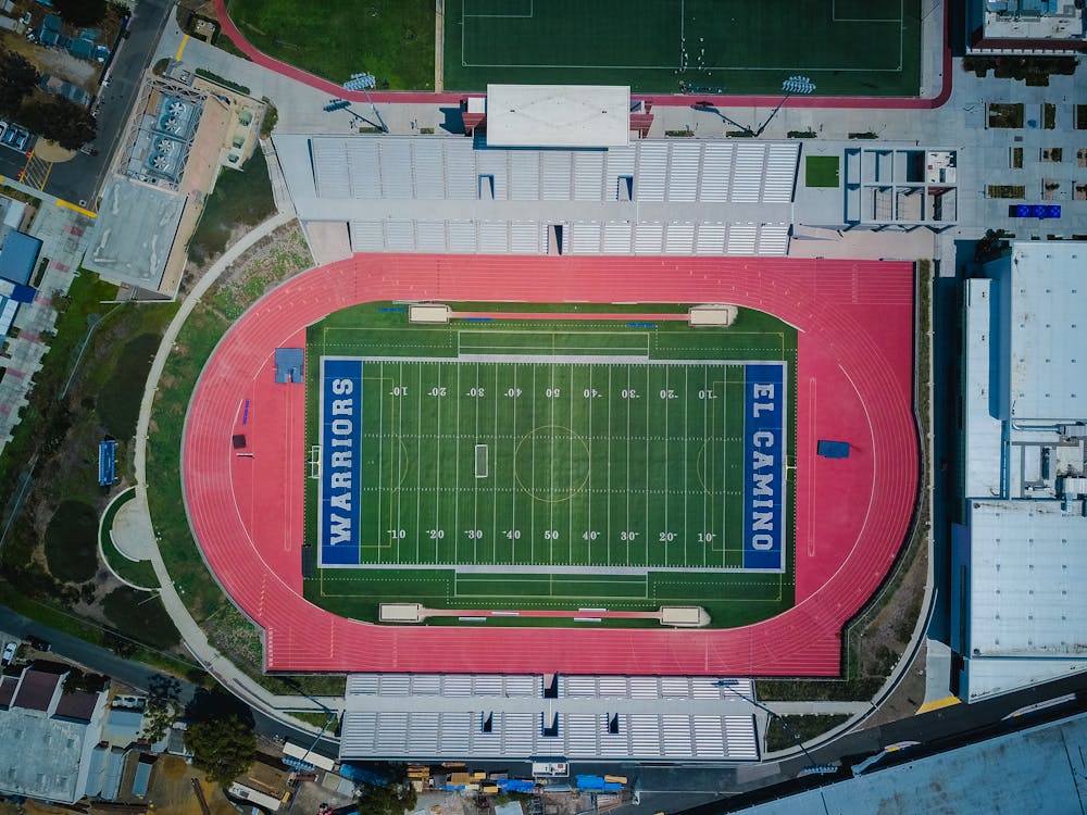 Free Aerial View of Football Stadium Near Buildings Stock Photo