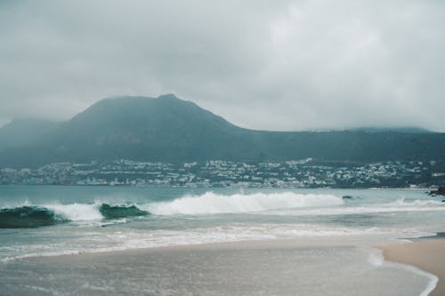 Strong Waves Crashing on the Sandy Shore of the Sea