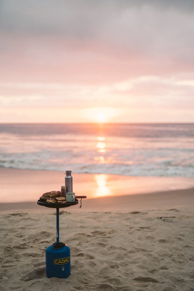 Gas Bottle With Table On Beach At Sunset