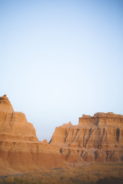 Brown Rock Formations Under White Sky