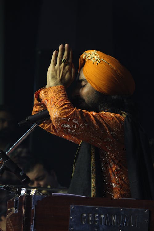 A Man in Turban using Microphone