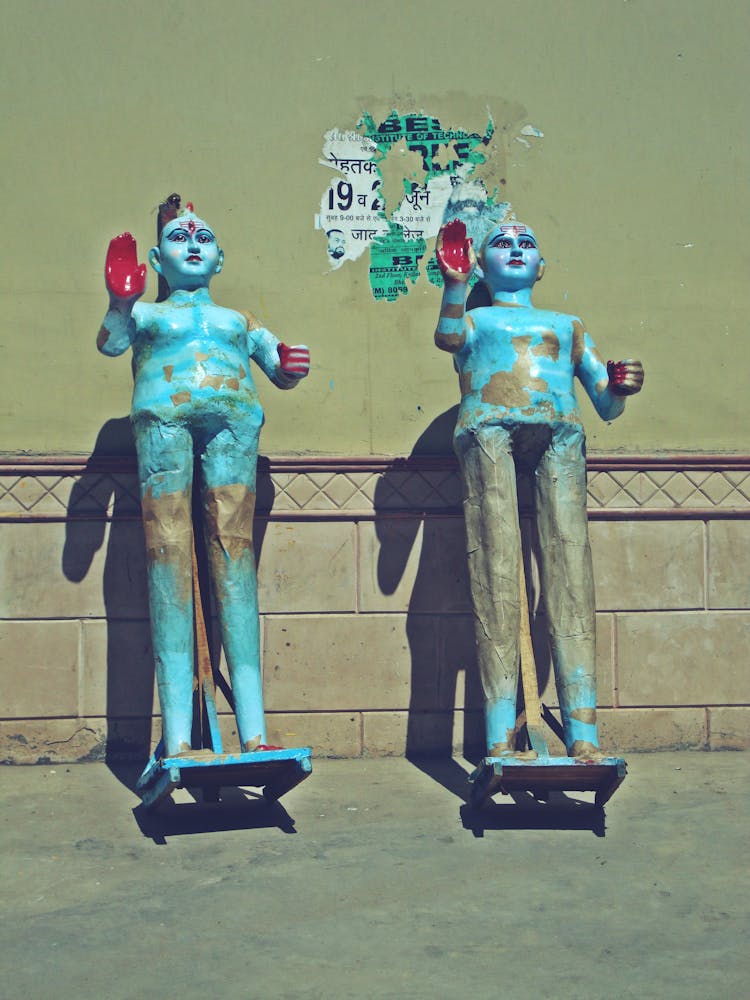 Blue Figurines Against A Wall 