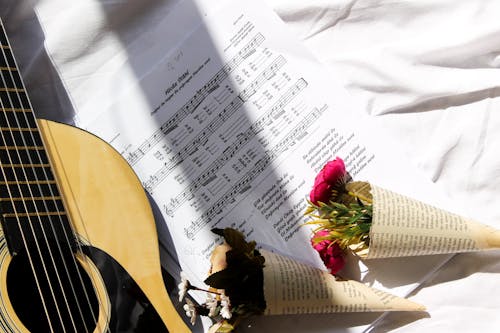 Free Overhead Shot of Bouquets of Flowers on Top of a Musical Composition Stock Photo
