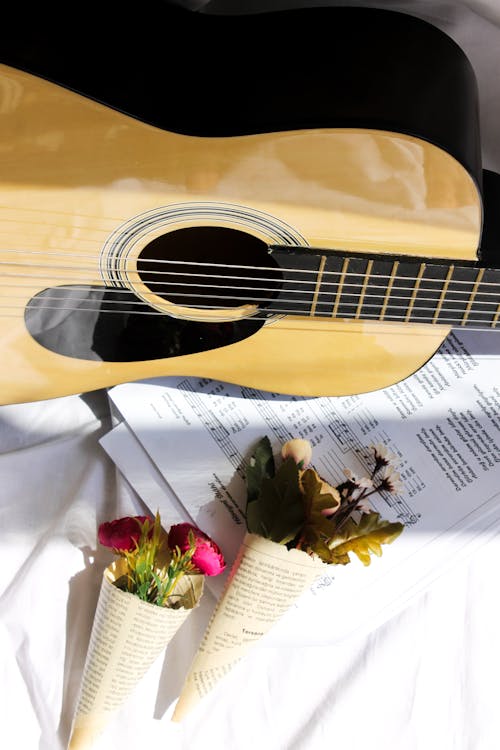 Free Overhead Shot of Bouquet of Flowers on Top of a Musical Composition  Stock Photo