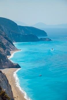 Stunning aerial shot capturing the vibrant blue waters and rocky Greek shoreline.