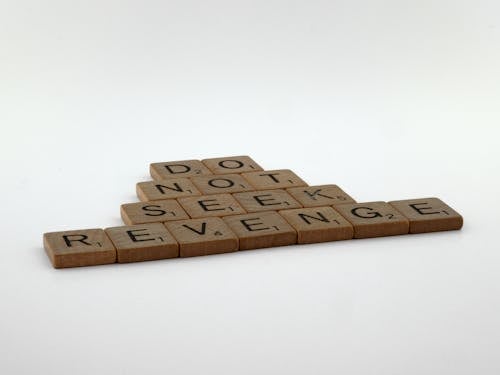 Brown Wooden Scrabble Pieces on White Surface