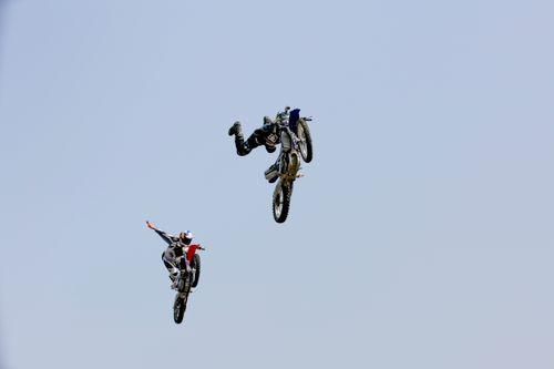 Free Two motocross riders perform breathtaking aerial stunts, showcasing skill and adrenaline. Stock Photo