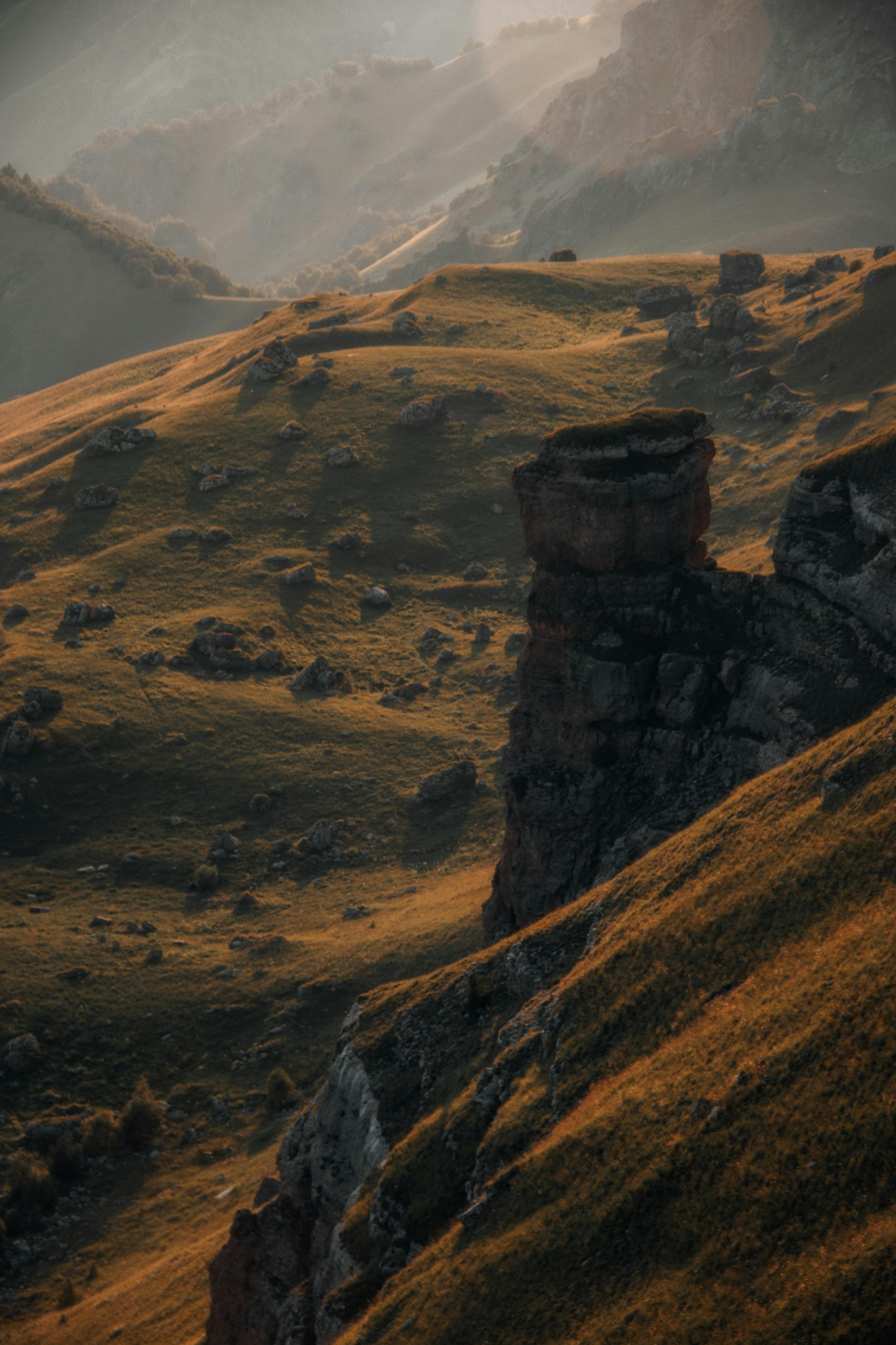 Breathtaking aerial shot of rugged mountain landscape with dramatic lighting and geological features.