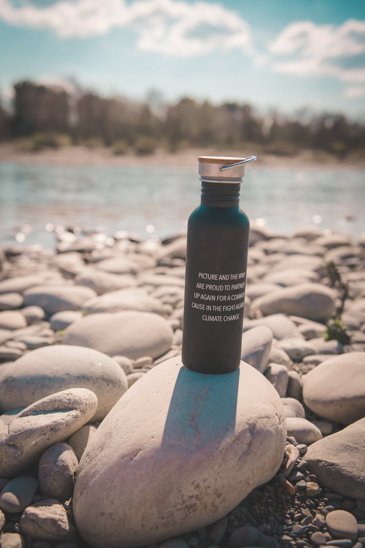 Thermos On Stones In Sunlight