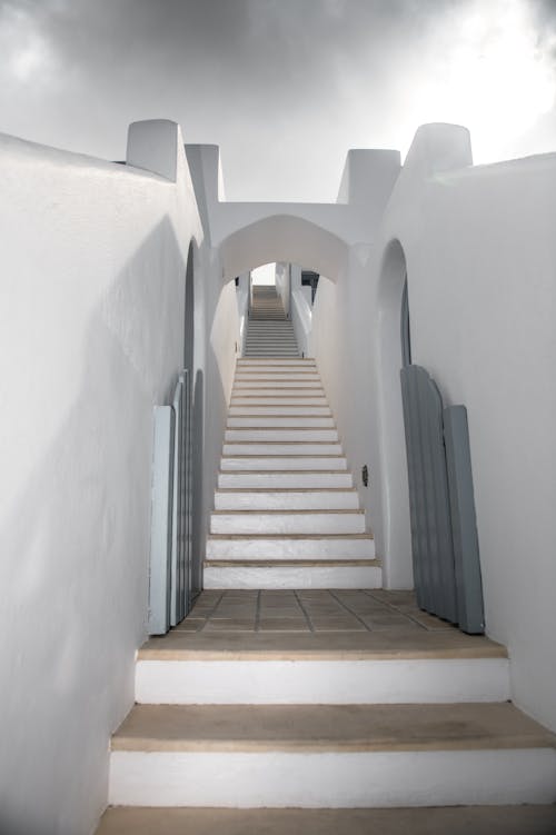 Free White Concrete Staircase Between White Concrete Walls
 Stock Photo