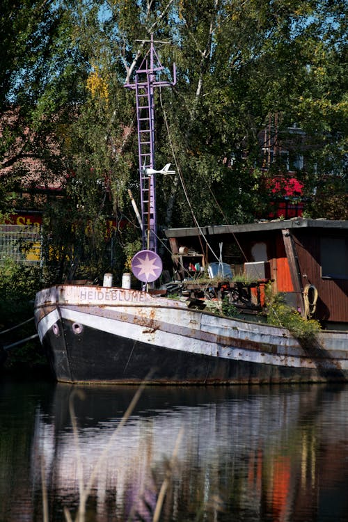 Wooden Motorboat Docked on Riverside