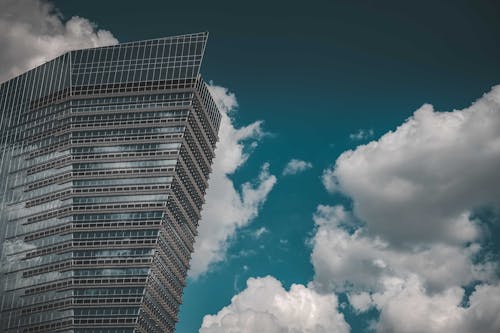 High Rise Building Under Blue Sky and White Clouds