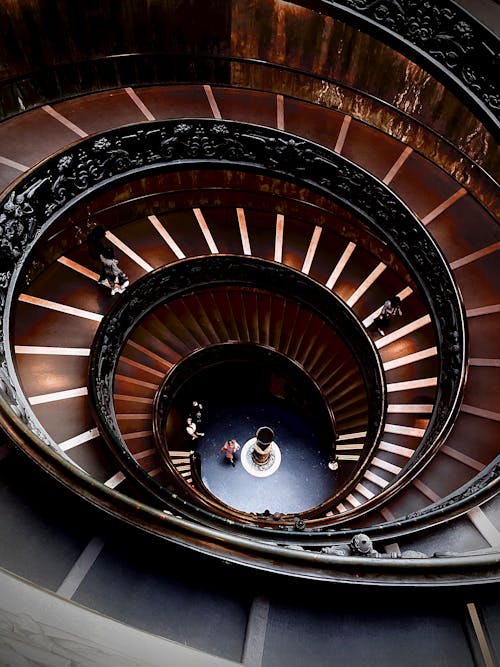 Free Brown Spiral Staircase With Black Metal Railings Stock Photo