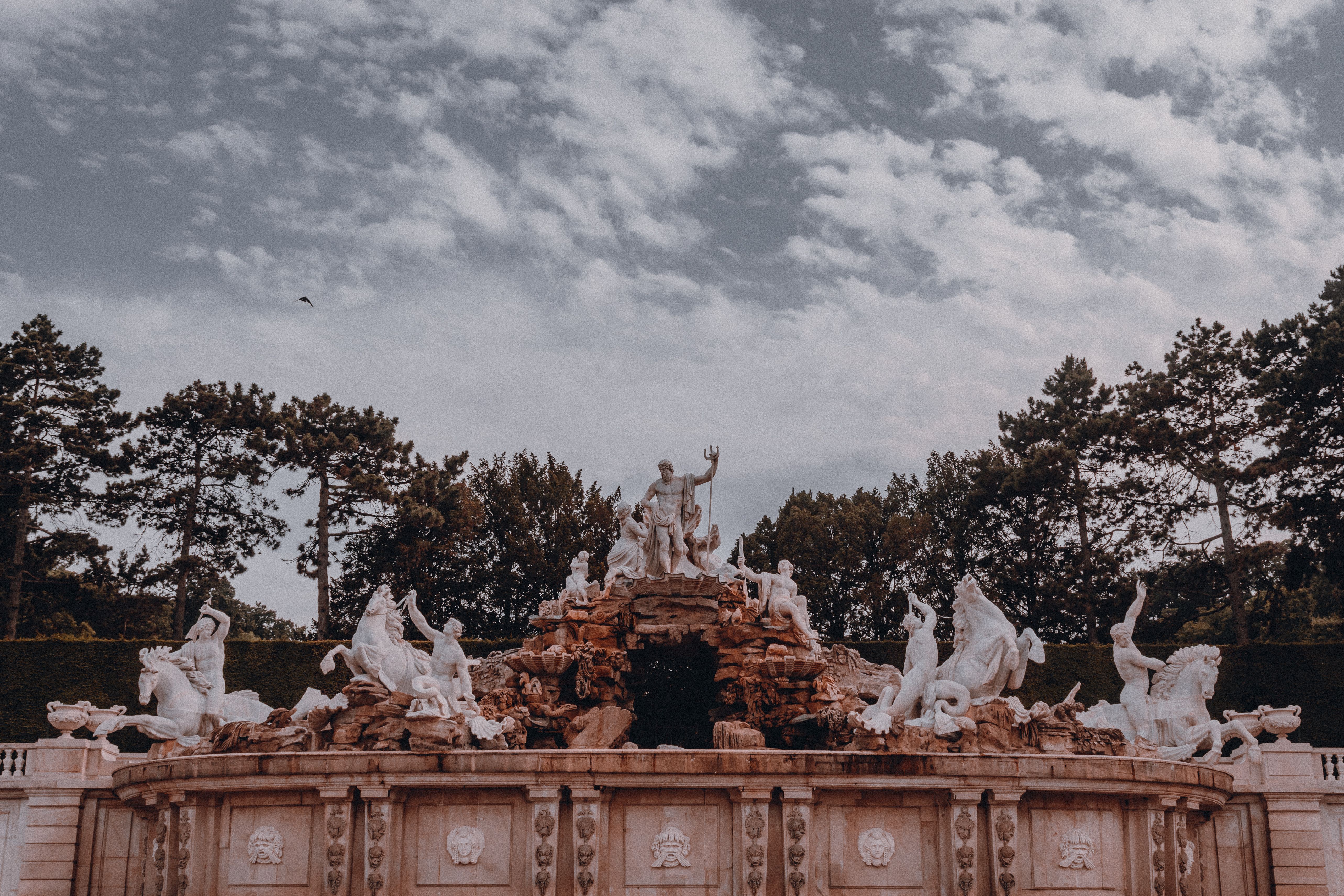 Fountain jets in the palace gardens with pine forest behind