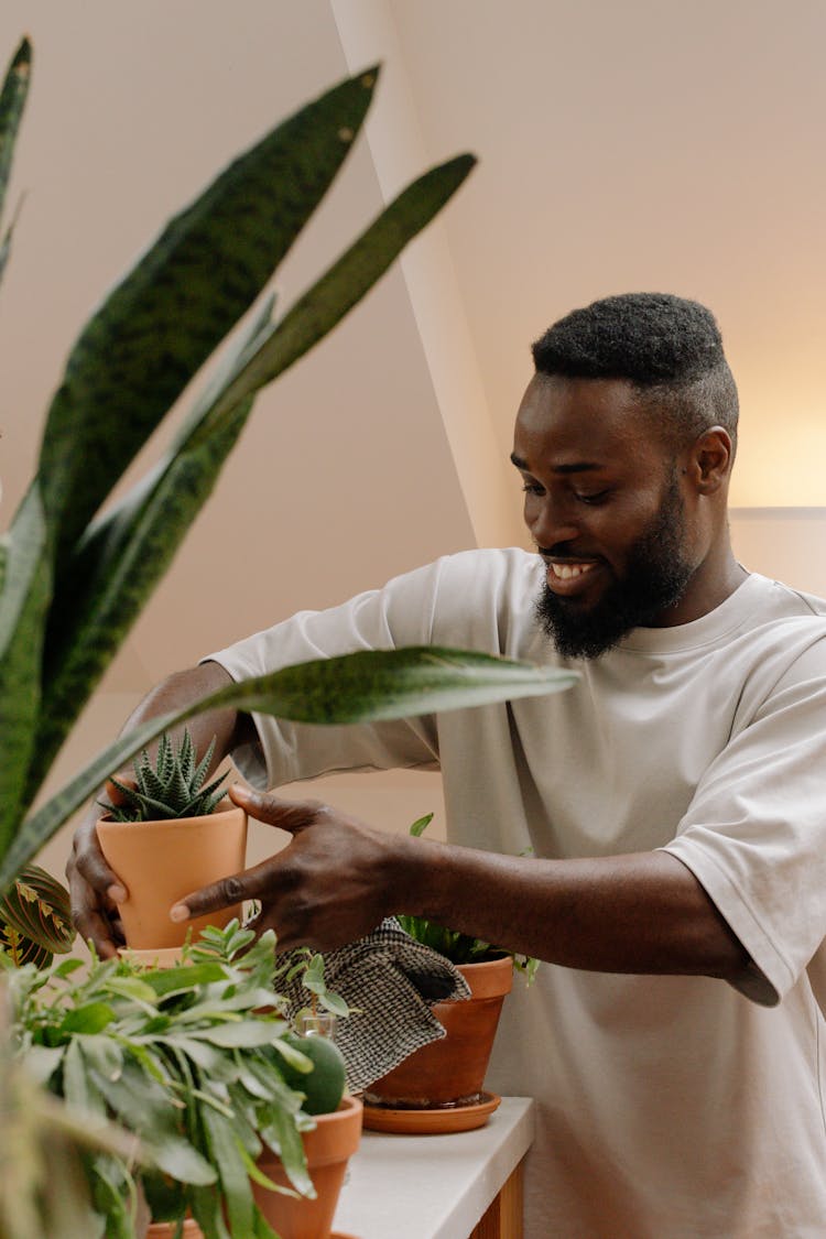 
A Bearded Man Holding A Potted Plant