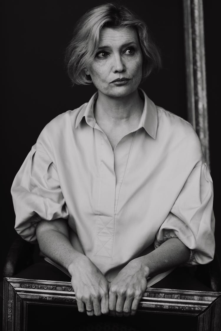 Black And White Portrait Of Woman Holding Frame