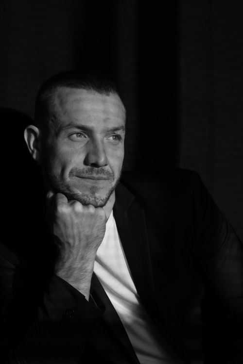 Free Moody black and white portrait of a thoughtful man in a dark setting, emphasizing introspection. Stock Photo