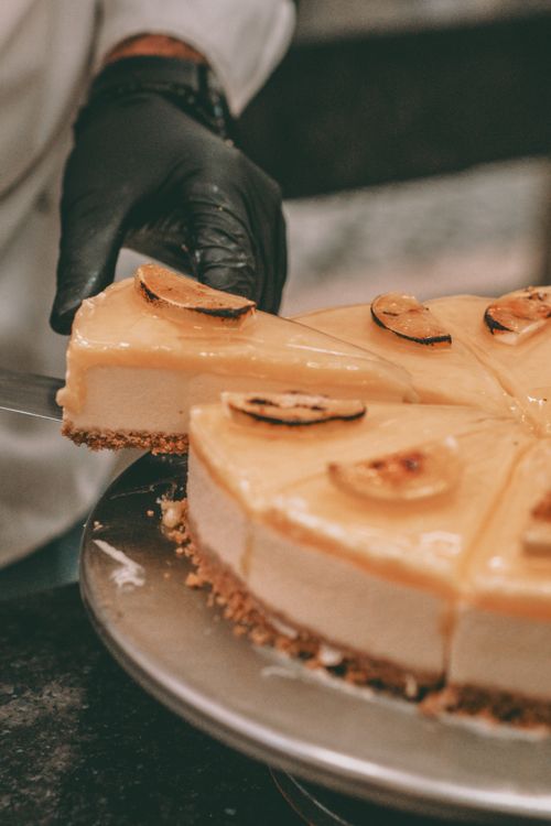 Free Close-up of a cheesecake slice being gracefully served, highlighting texture and detail. Stock Photo