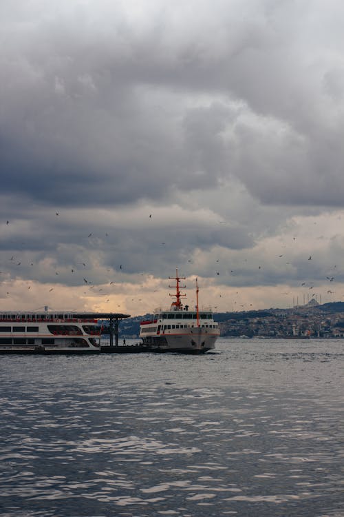 Free Ferry Boats Sailing on the Sky Under Cloudy Sky Stock Photo