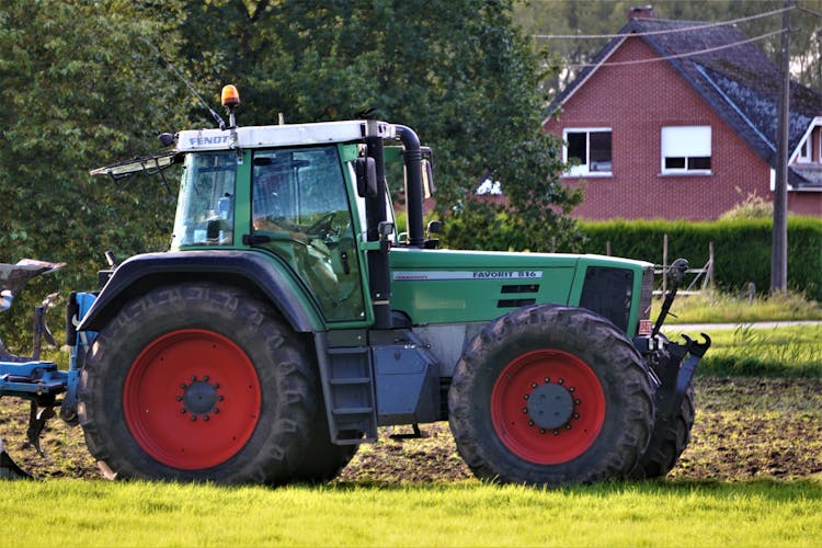 Man Driving A Tractor On A Farm