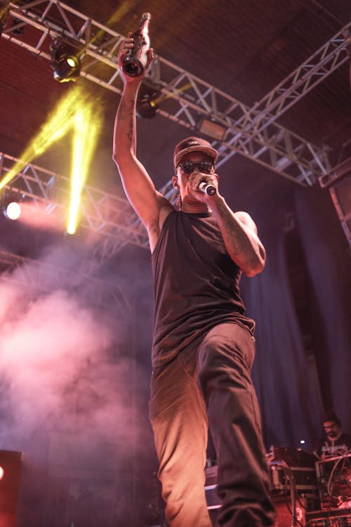 Man Holding Microphone and Bottle